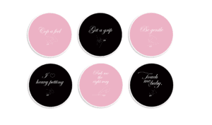 Six different pink and black coasters with a message.